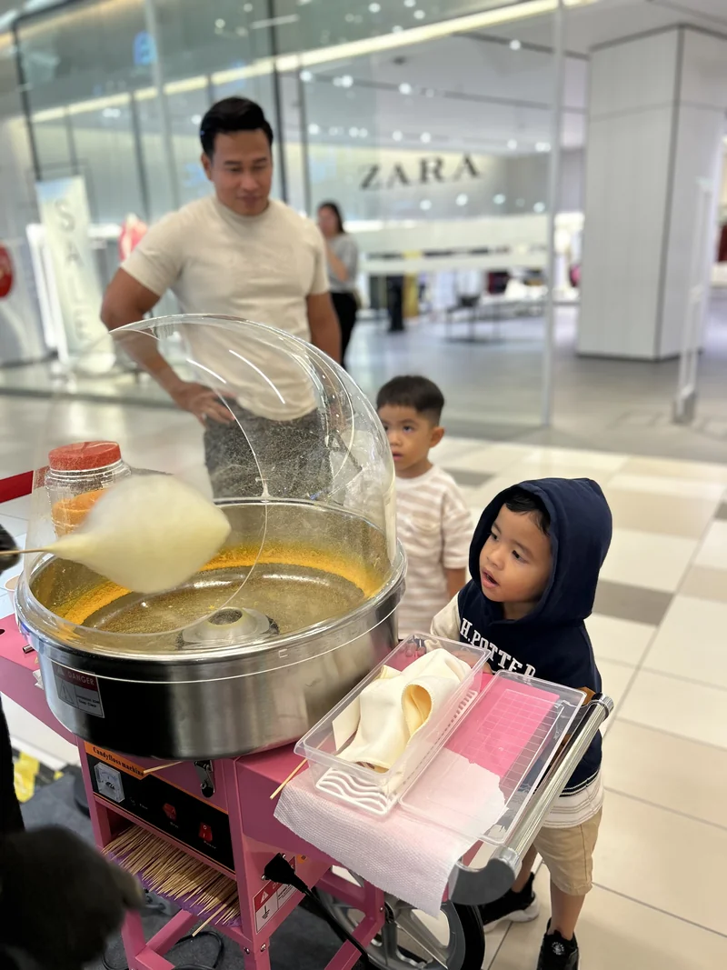 The pink candy-floss machine with stainless-steel bowl being used at MyTOWN